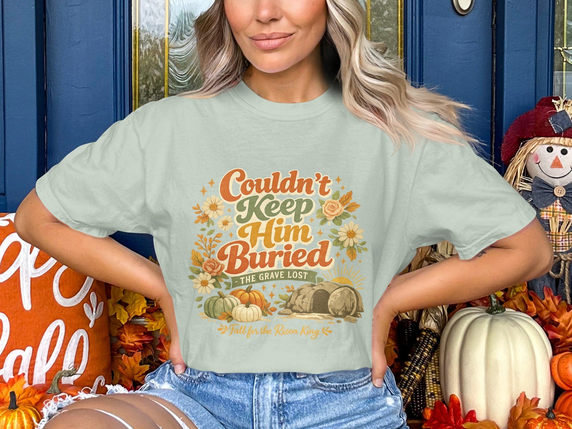 Light green t-shirt with "Couldn't Keep Him Buried - The Grave Lost" graphic.
