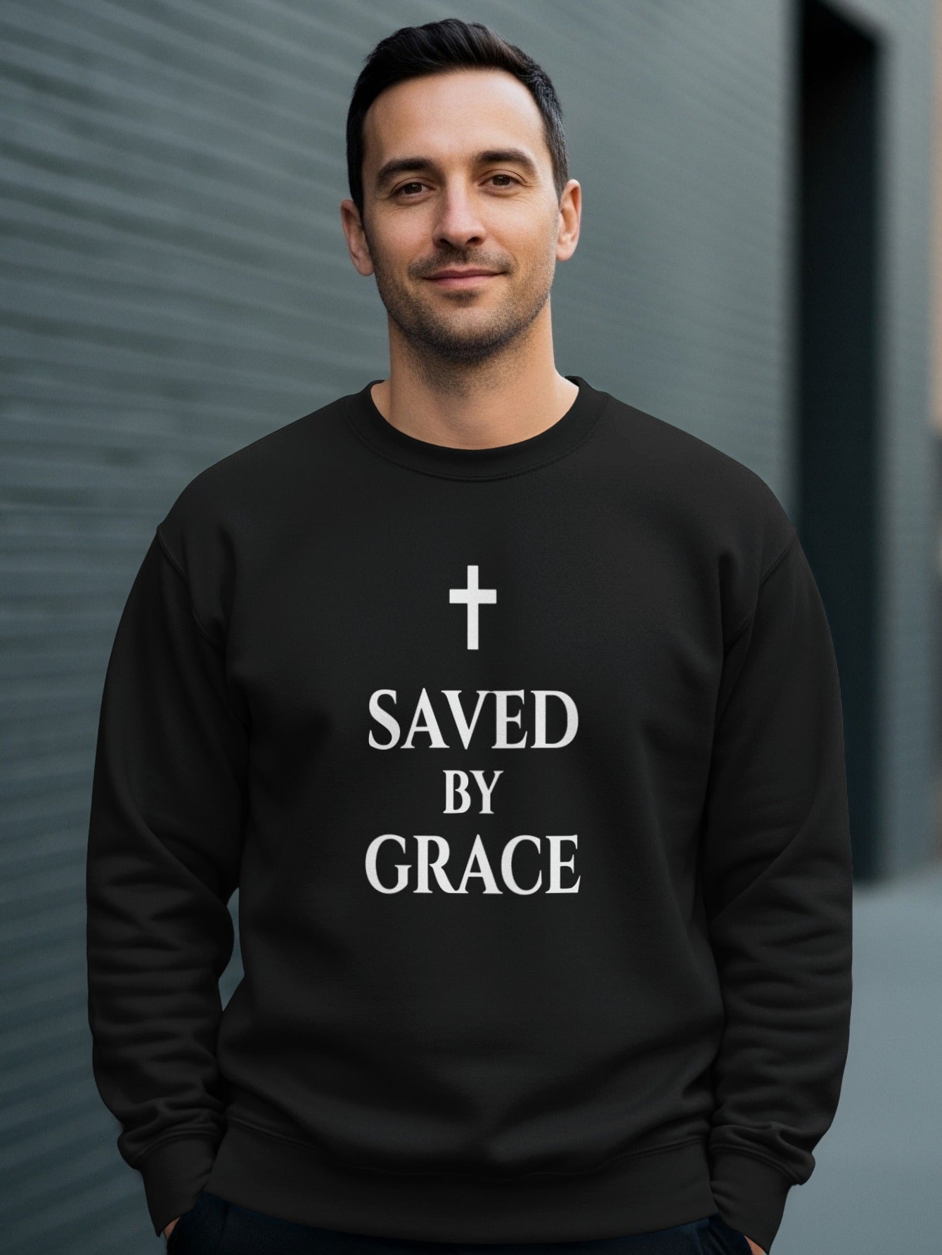 Black crewneck sweatshirt with white "SAVED BY GRACE" text and cross.