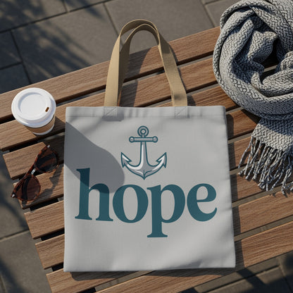 Tote bag with anchor and "hope" text, placed on a wooden bench.