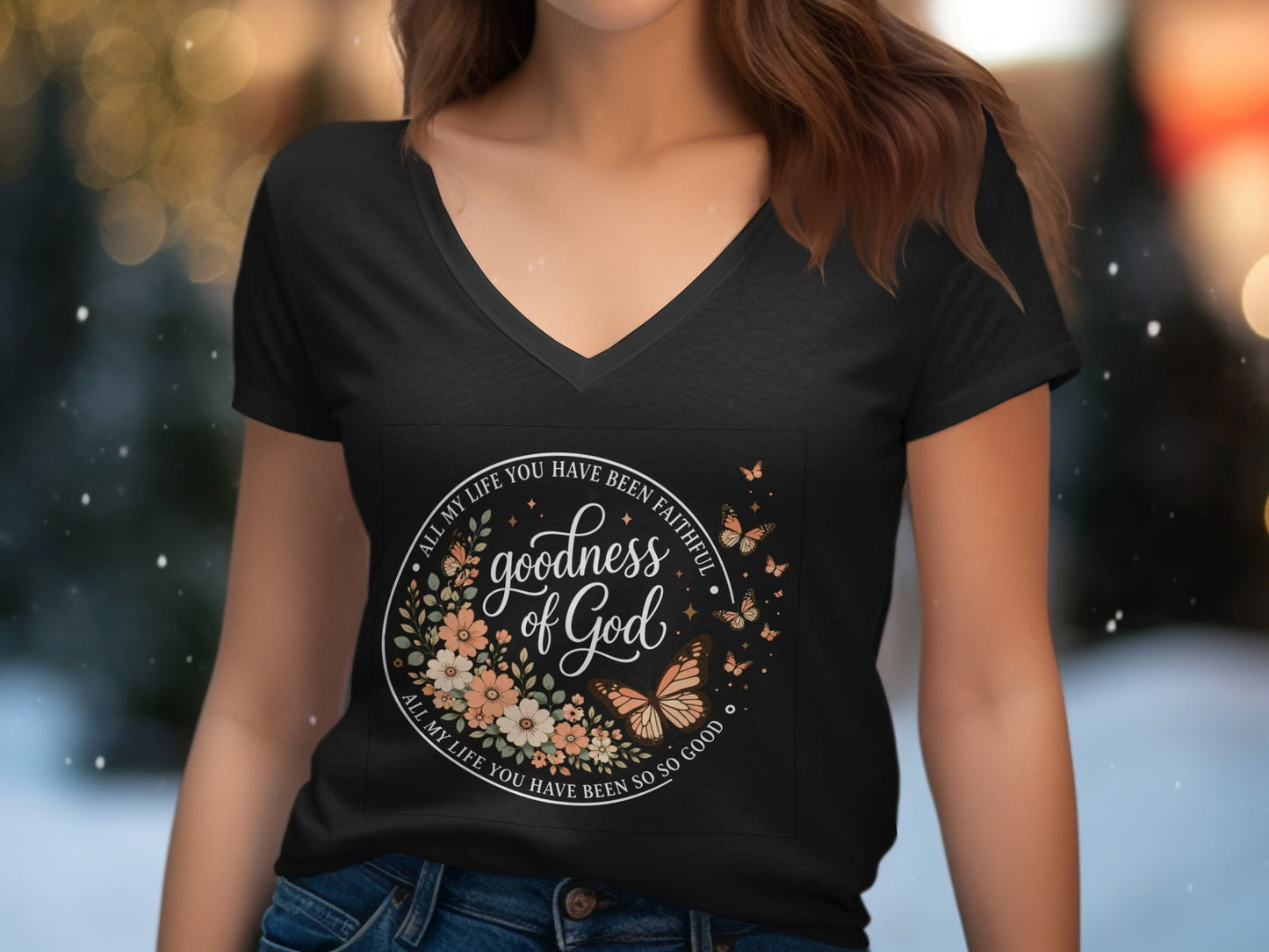 Black v-neck t-shirt with "Goodness of God" in circular floral design.