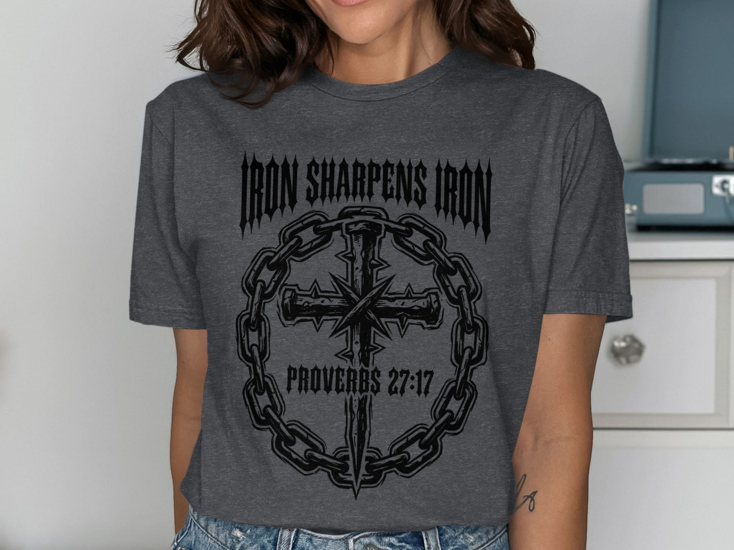 Dark grey t-shirt with a chain-wrapped cross and "Iron Sharpens Iron Proverbs 27:17" text.