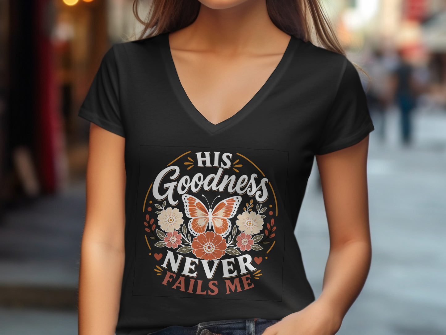 Black v-neck t-shirt with "His Goodness Never Fails Me" text and floral design.