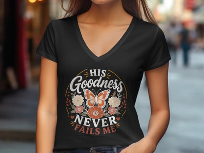 Black v-neck t-shirt with "His Goodness Never Fails Me" text and floral design.