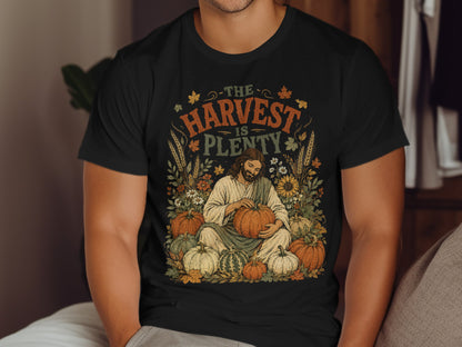 T-shirt with Jesus holding pumpkin, "The Harvest is Plenty" text.