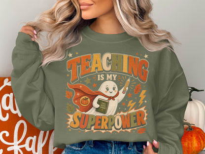 Green sweatshirt with ghost character and "Teaching is my Superpower" text.