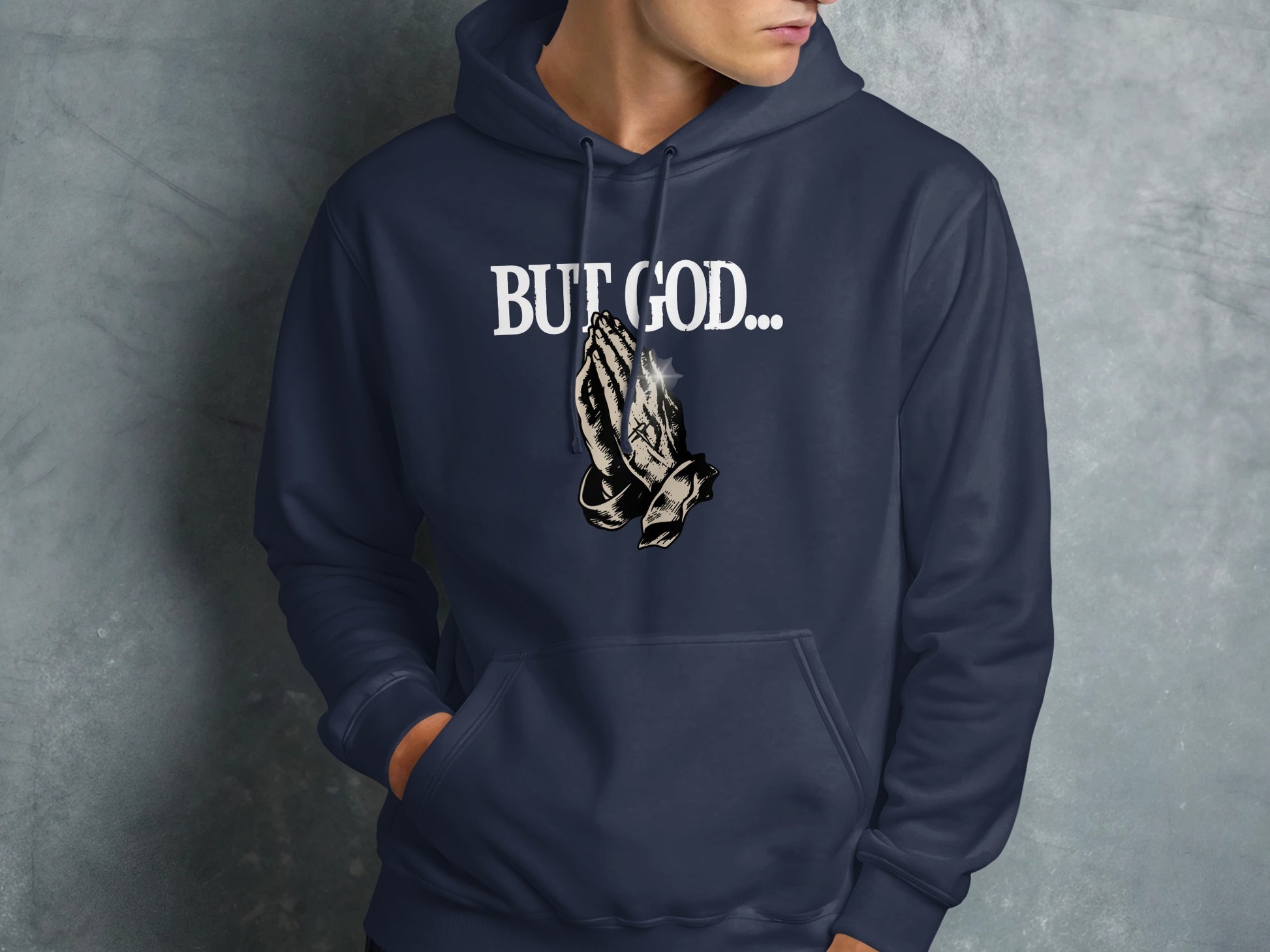 Navy hoodie with praying hands and "BUT GOD..." text graphic.