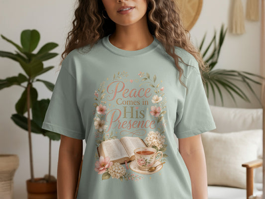 Light green t-shirt with floral wreath and text "Peace Comes in His Presence".