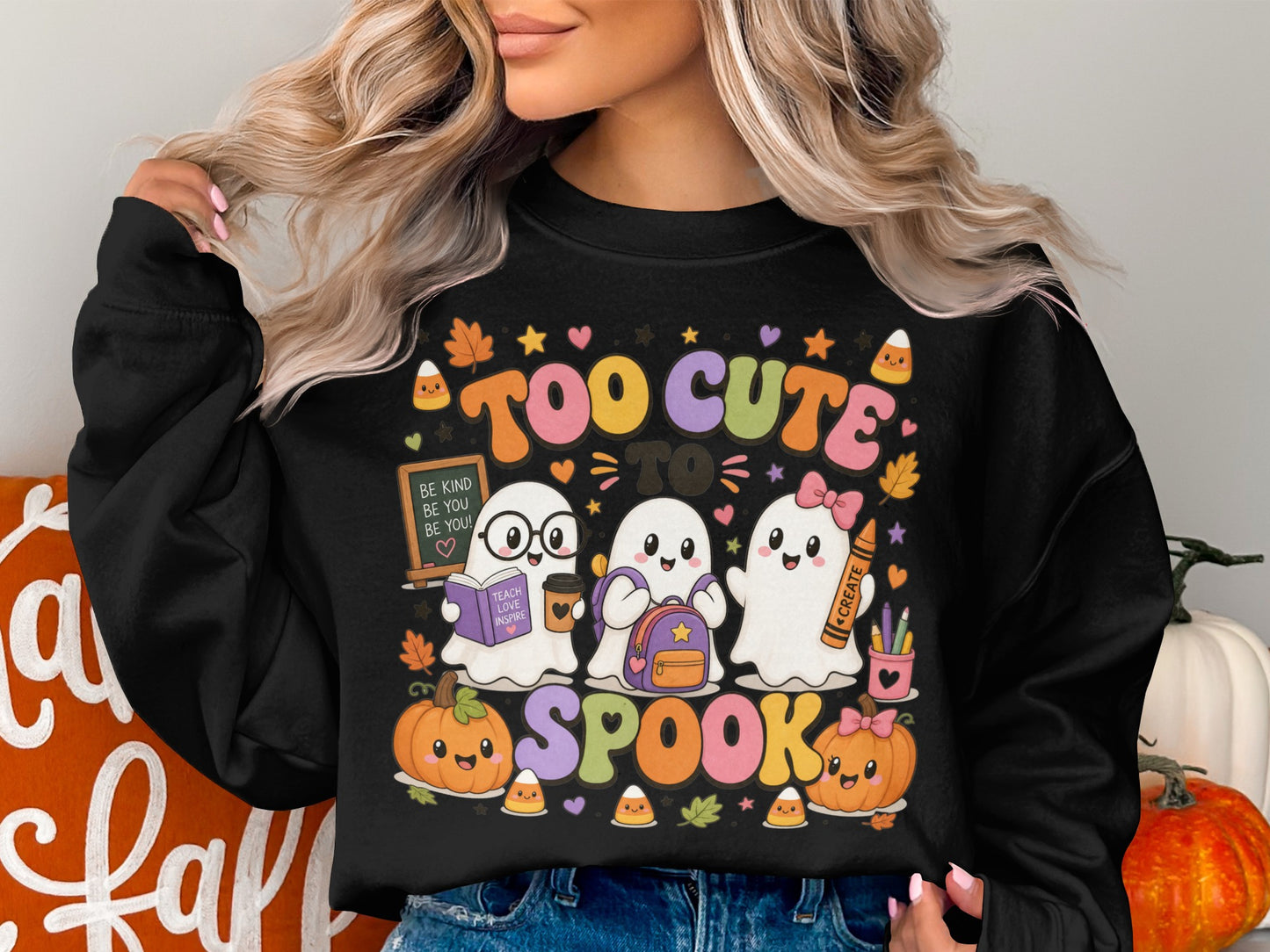 Black sweatshirt with "Too Cute to Spook" featuring ghosts, pumpkins, and school supplies.