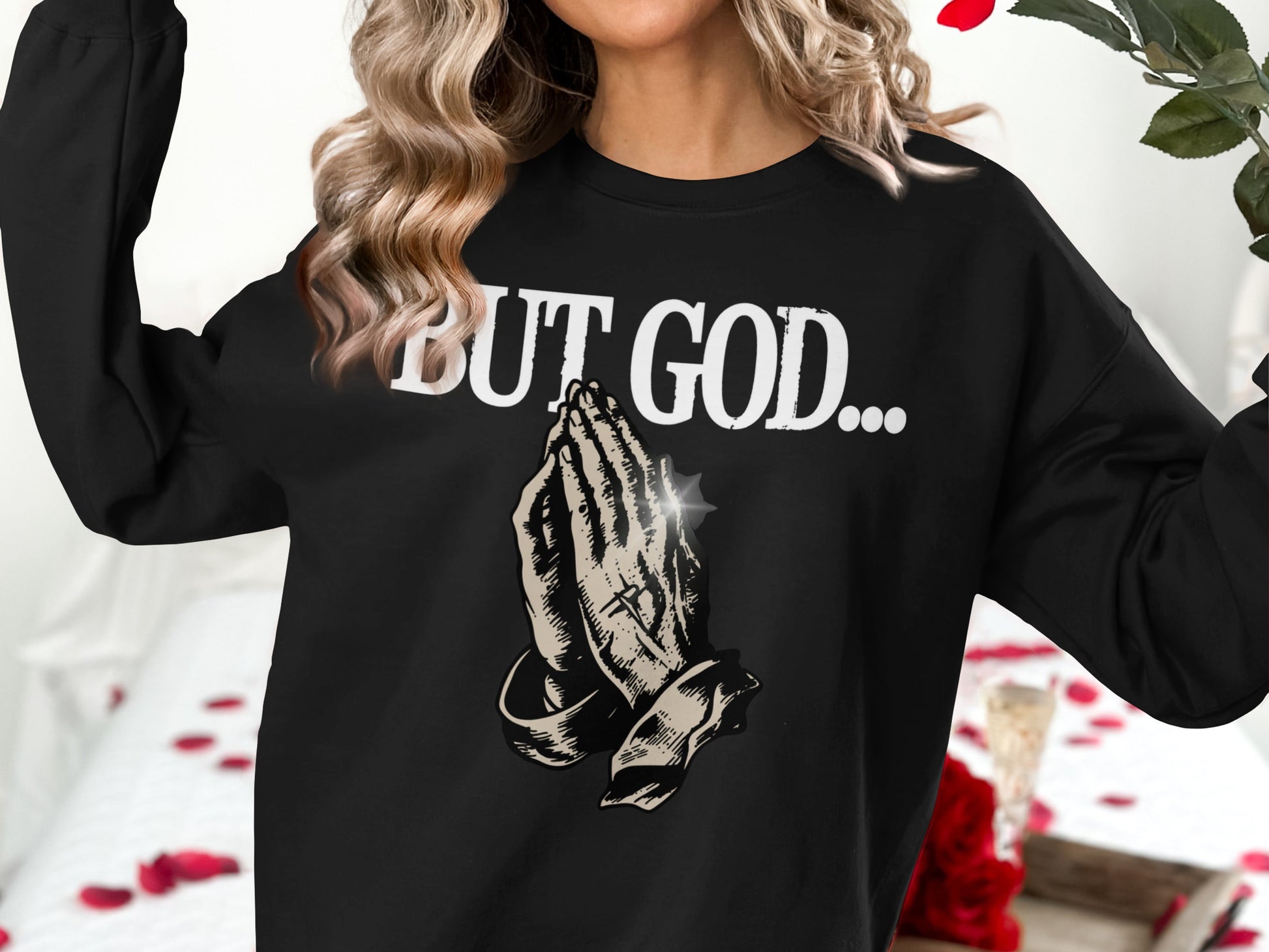 Black sweatshirt with praying hands graphic and "BUT GOD..." text.