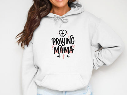 White hoodie with "Praying Mama" text and cross graphics.