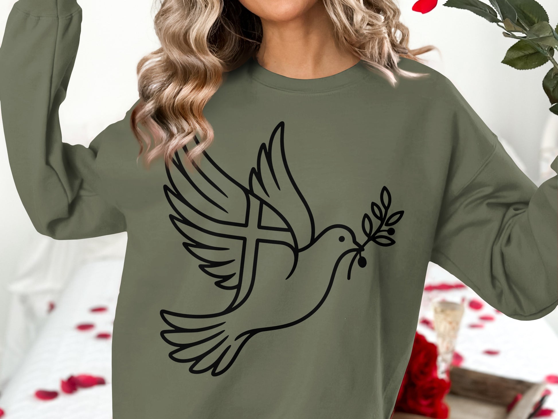Olive green sweatshirt with a black line drawing of a dove with a cross in its wing.