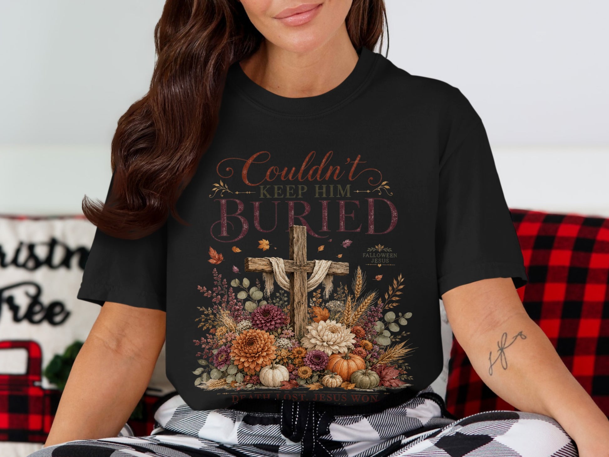 Black t-shirt with "Couldn't Keep Him Buried" graphic and a cross.
