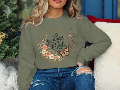 Green crewneck sweatshirt with "Goodness of God" floral design and butterflies.