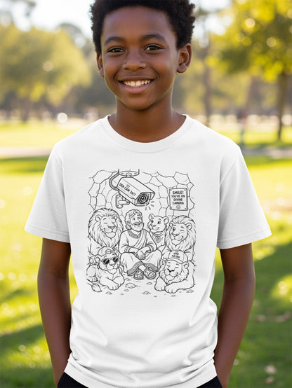 Boy in t-shirt with coloring book design of Daniel in lion's den.