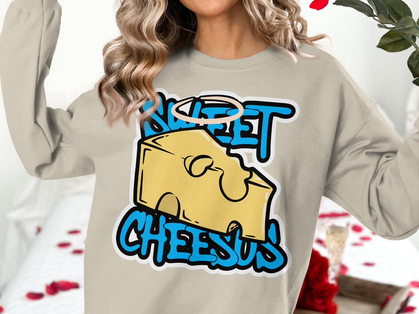 Beige sweatshirt with "SWEET CHEESUS" text and cartoon cheese slice.