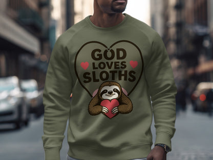 Olive green sweatshirt with a heart-shaped graphic featuring a sloth holding a pink heart and text reading "God Loves Sloths".