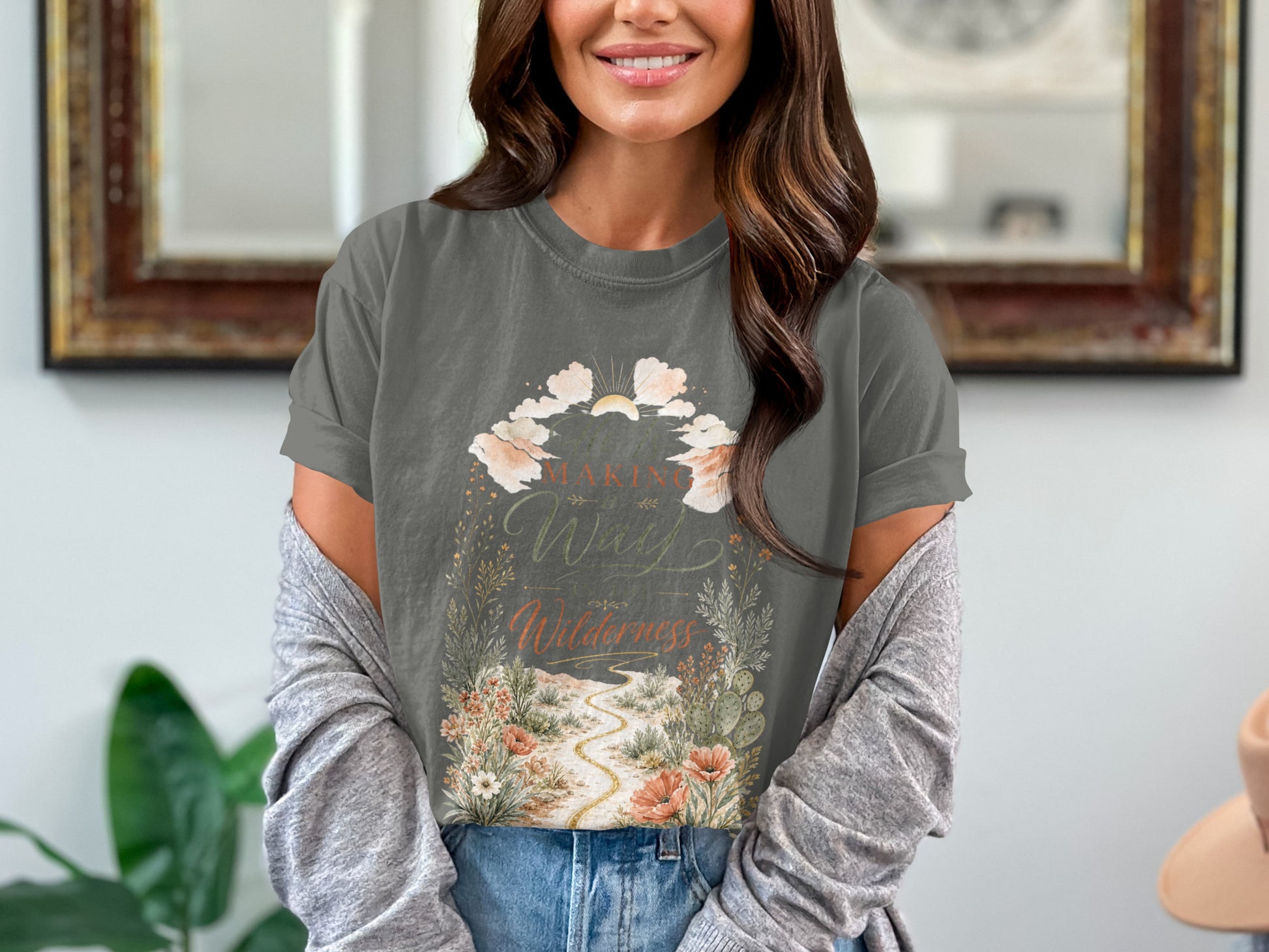 Gray t-shirt with floral and desert landscape graphic that reads "Making Way in the Wilderness."