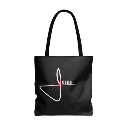 Black tote bag with white "Jesus" lettering and a red cross symbol.