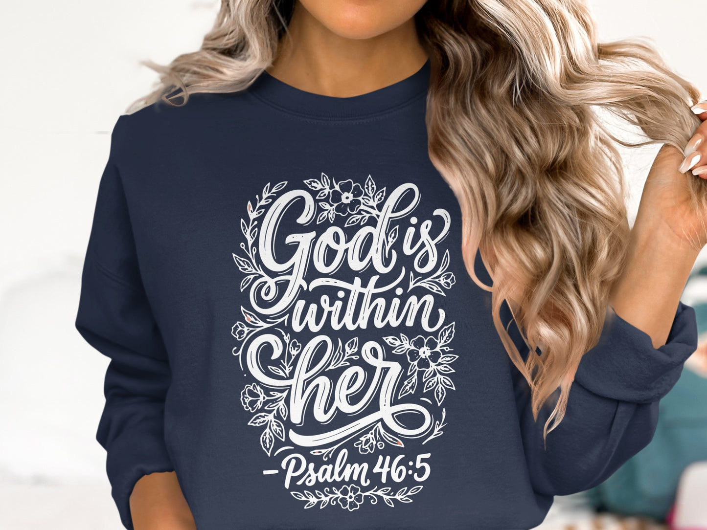 Navy sweatshirt with "God is within her" floral design and Psalm 46:5.