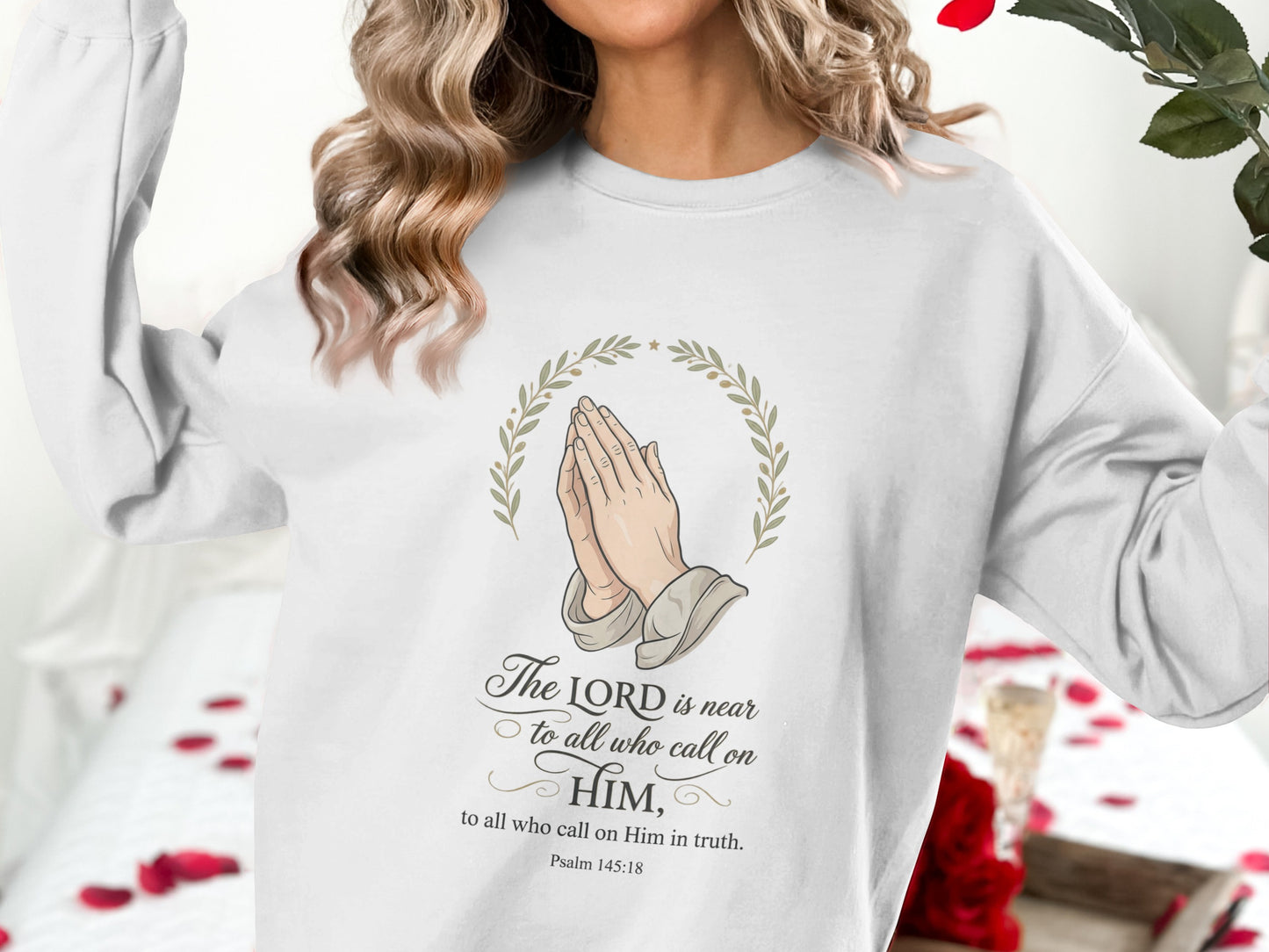 White sweatshirt with "The Lord is near" Psalm 145:18 design and praying hands.