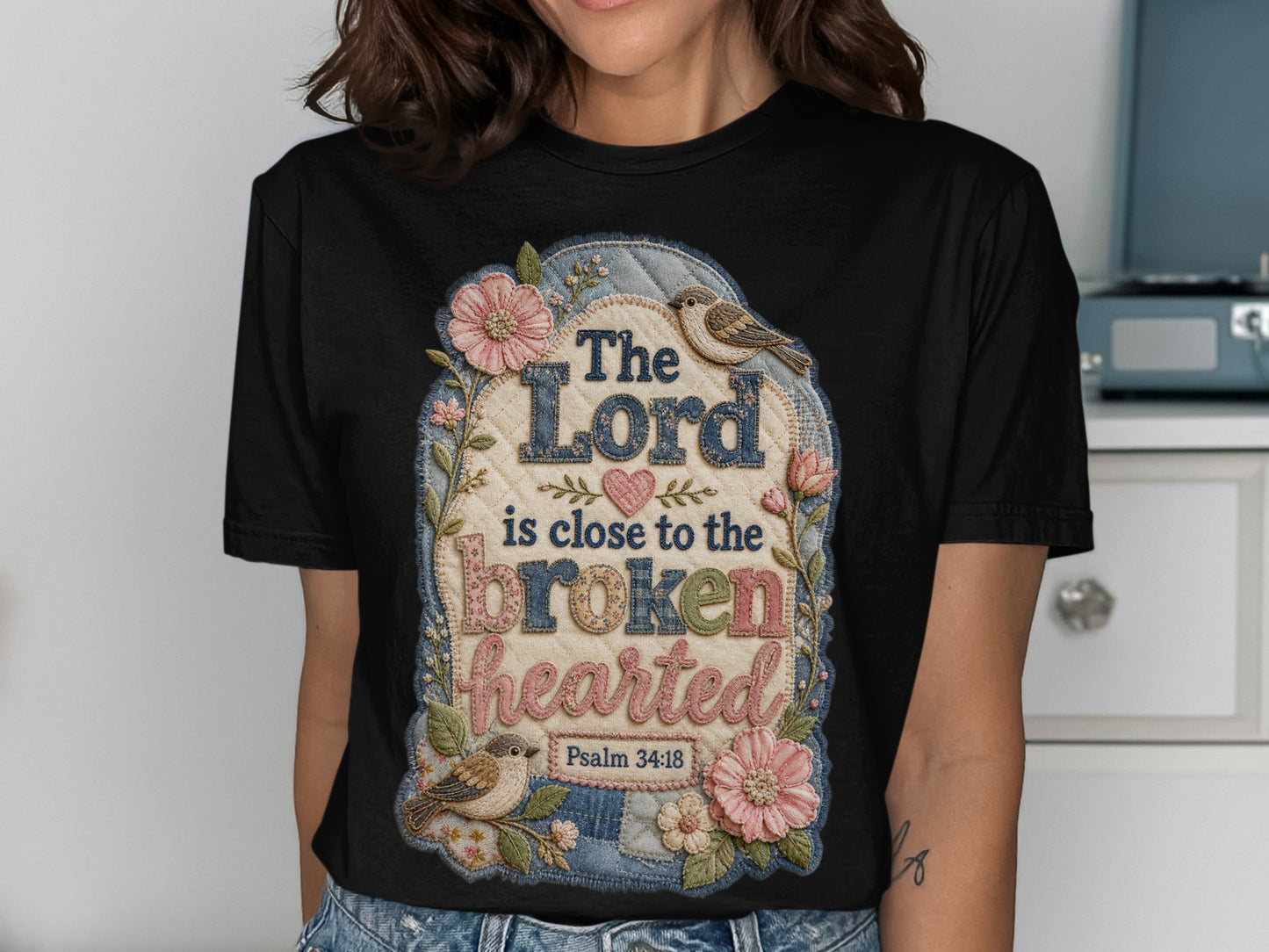 Black t-shirt with "The Lord is close to the brokenhearted" scripture.