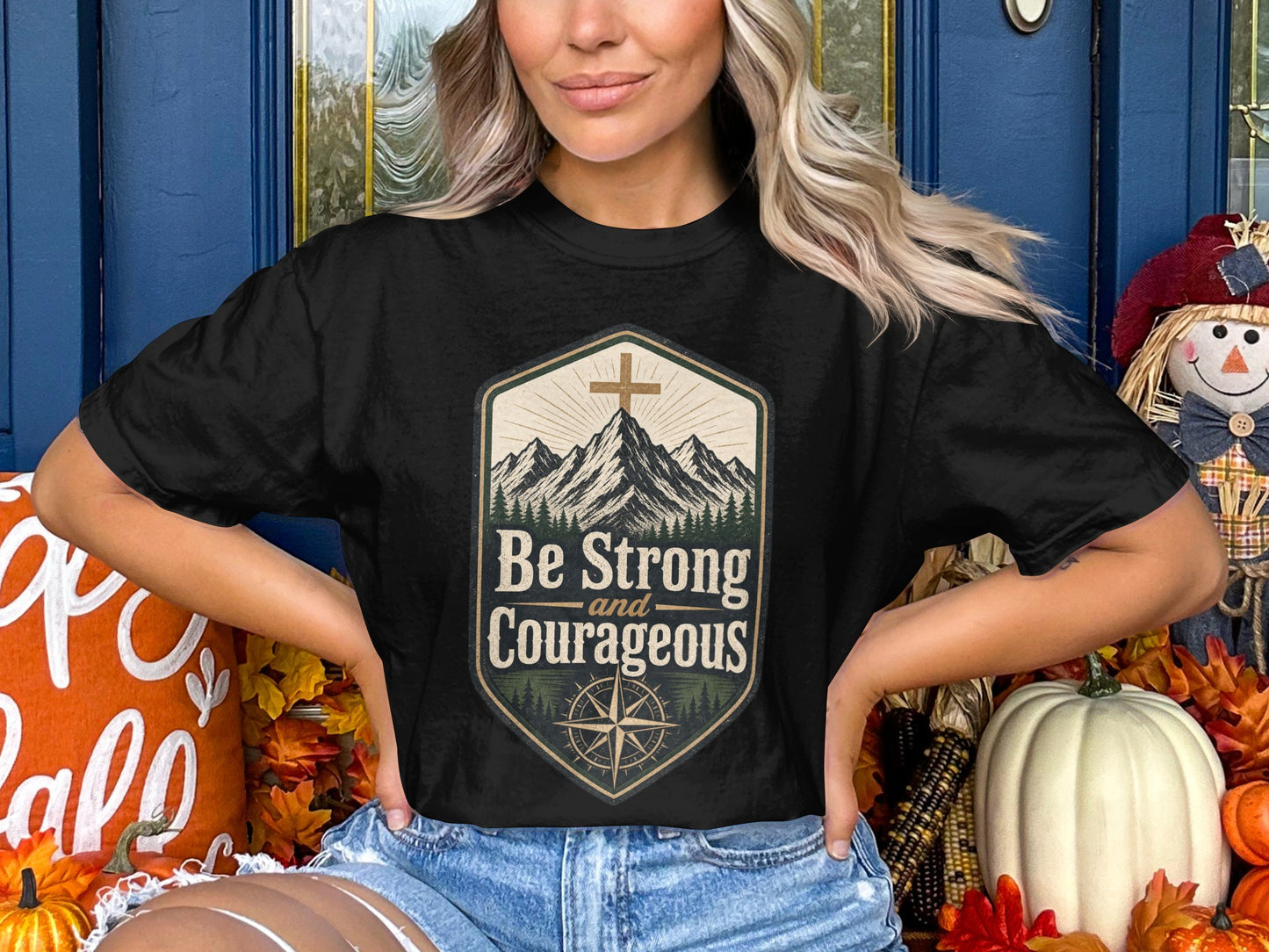 Black t-shirt with "Be Strong and Courageous" text, mountains, and compass design.