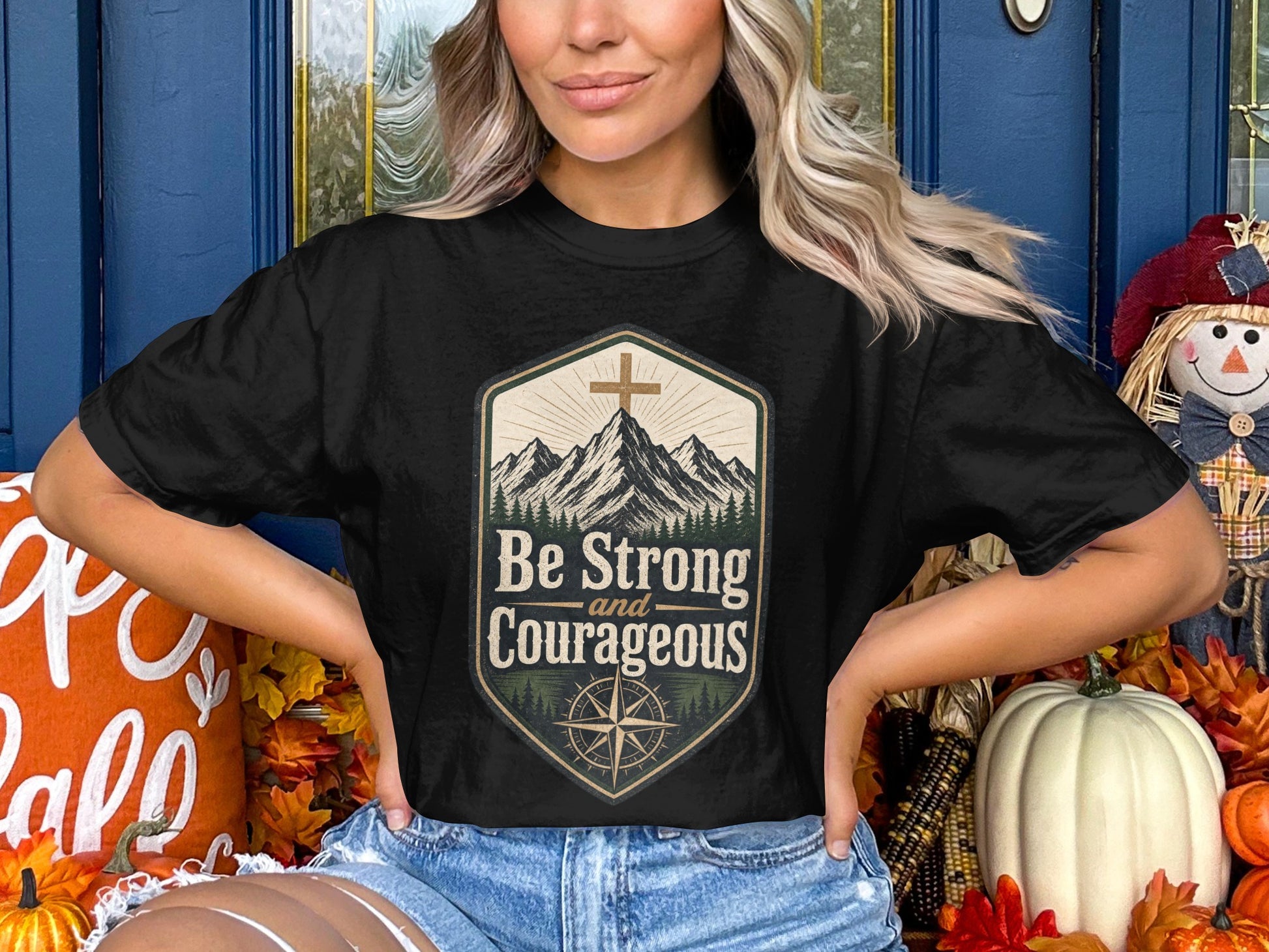 Black t-shirt with "Be Strong and Courageous" text, mountains, and compass design.