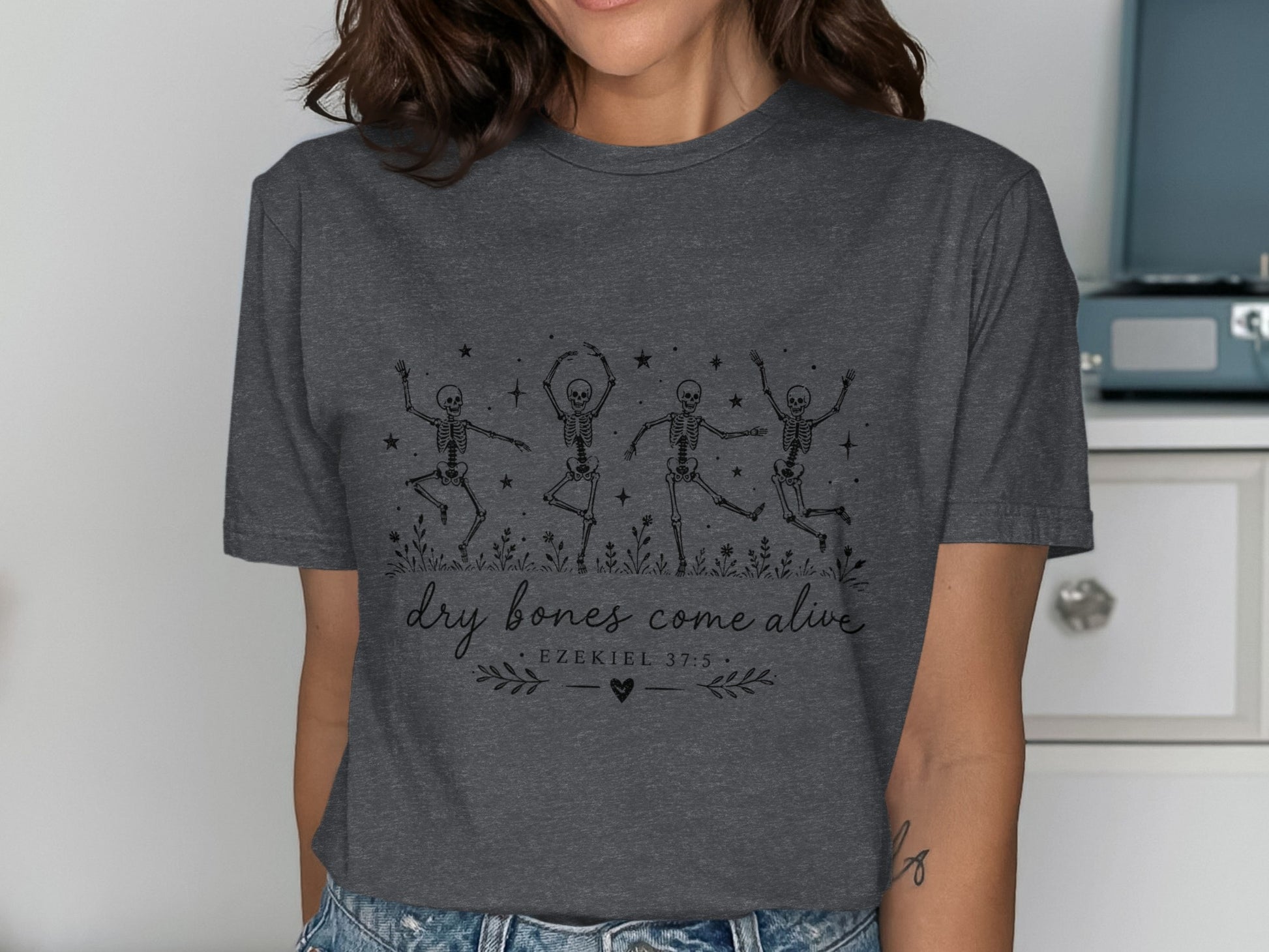 Dark gray t-shirt with dancing skeletons and "dry bones come alive" text.