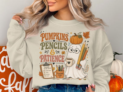 Ghost with glasses holding coffee and pencils, on sweatshirt with text "Pumpkins, Pencils & Patience".