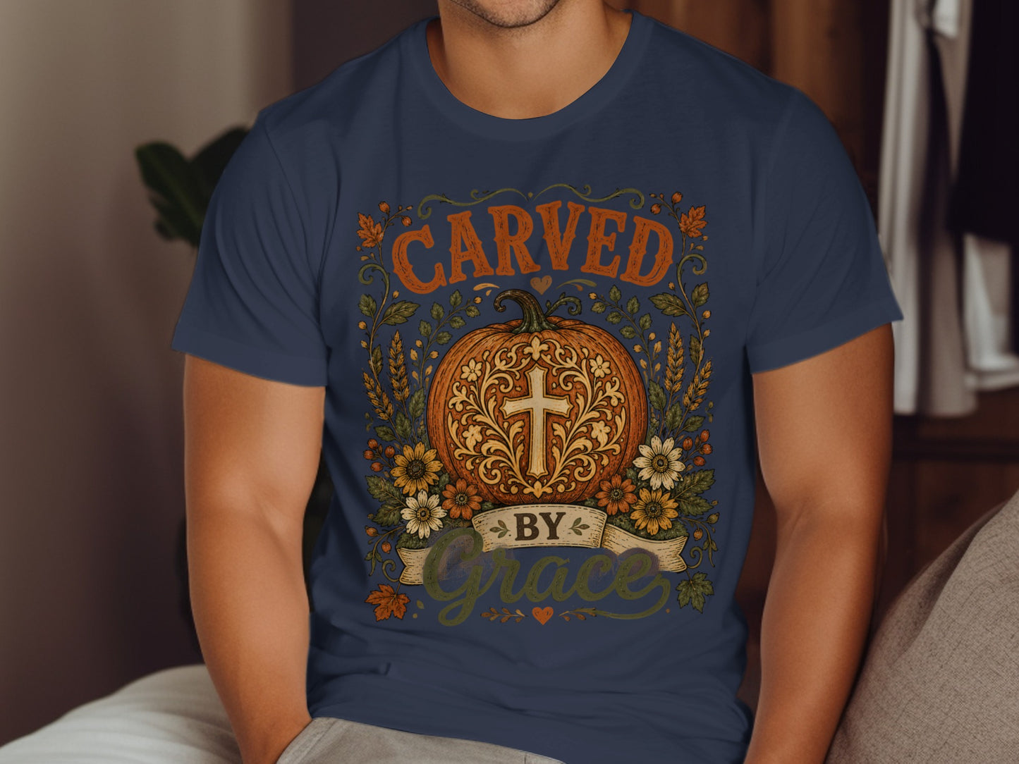 T-shirt with "Carved by Grace" text and decorative pumpkin.