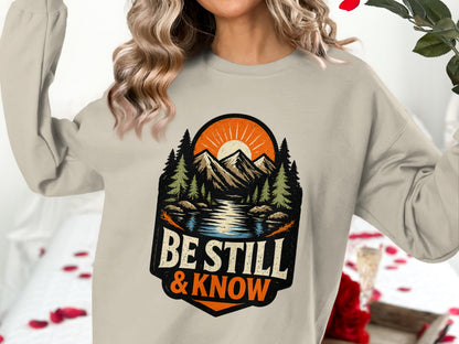 "Be Still & Know" graphic with mountains, trees, and sun.