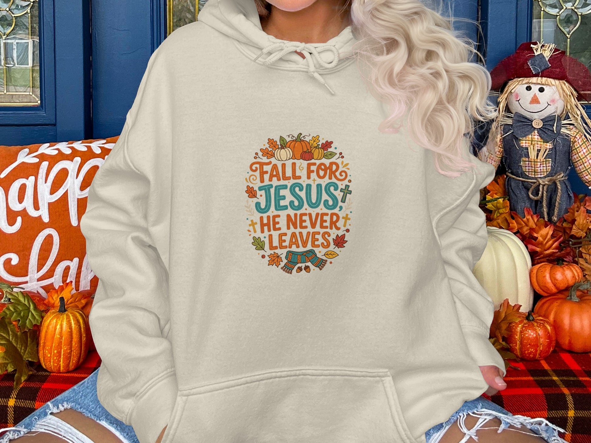 Cream hoodie with "Fall for Jesus he never leaves" text and autumn leaves.