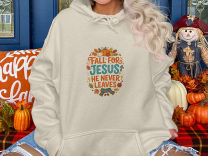 Cream hoodie with "Fall for Jesus he never leaves" text and autumn leaves.