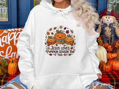 Three smiling pumpkins wearing scarves and plaid bibs on a hoodie.