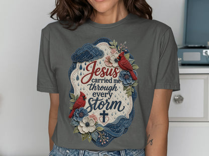 Gray t-shirt with "Jesus carried me through every storm" text and floral design.
