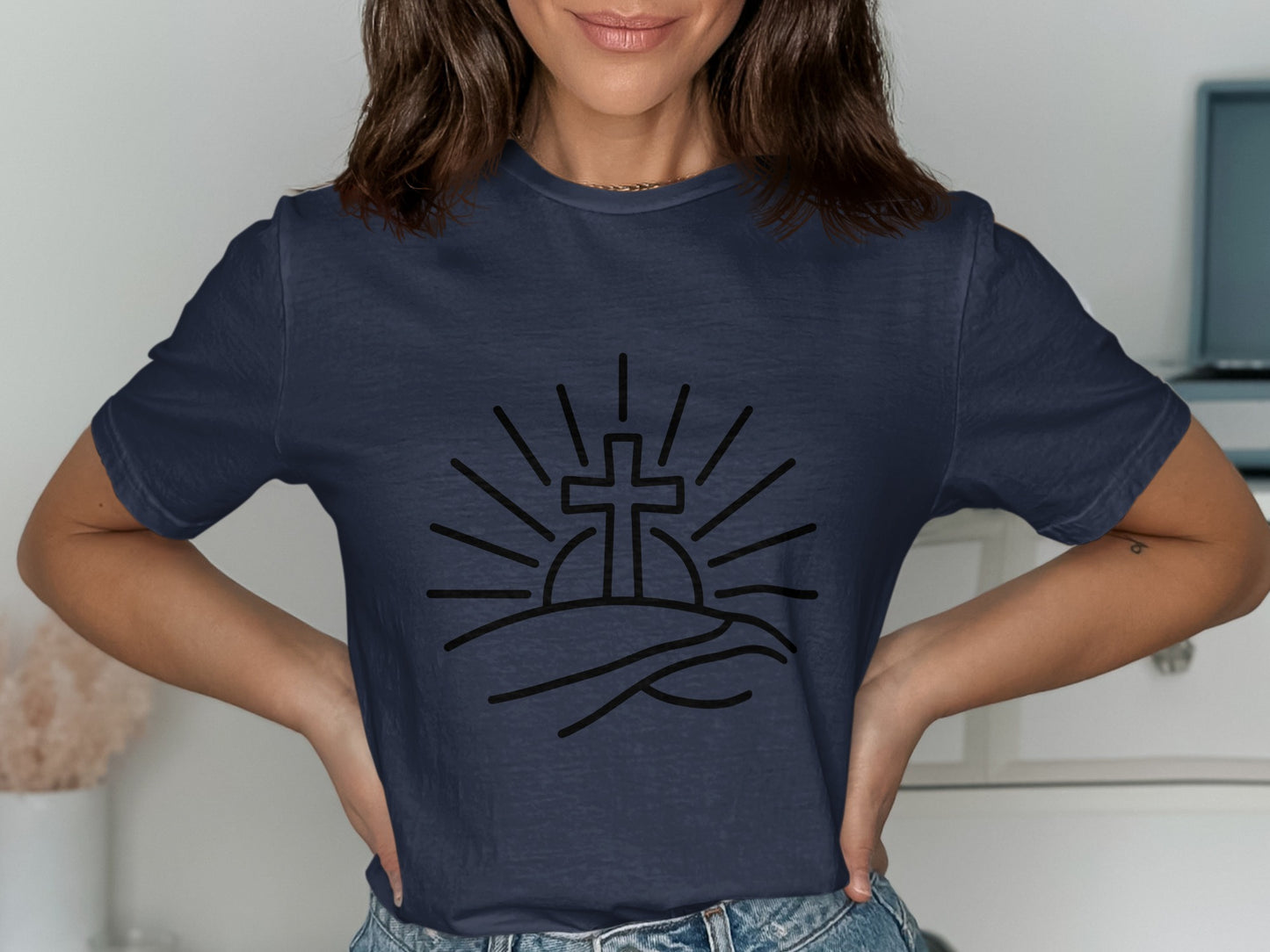 Dark navy t-shirt with a black line art graphic of a cross rising over hills.