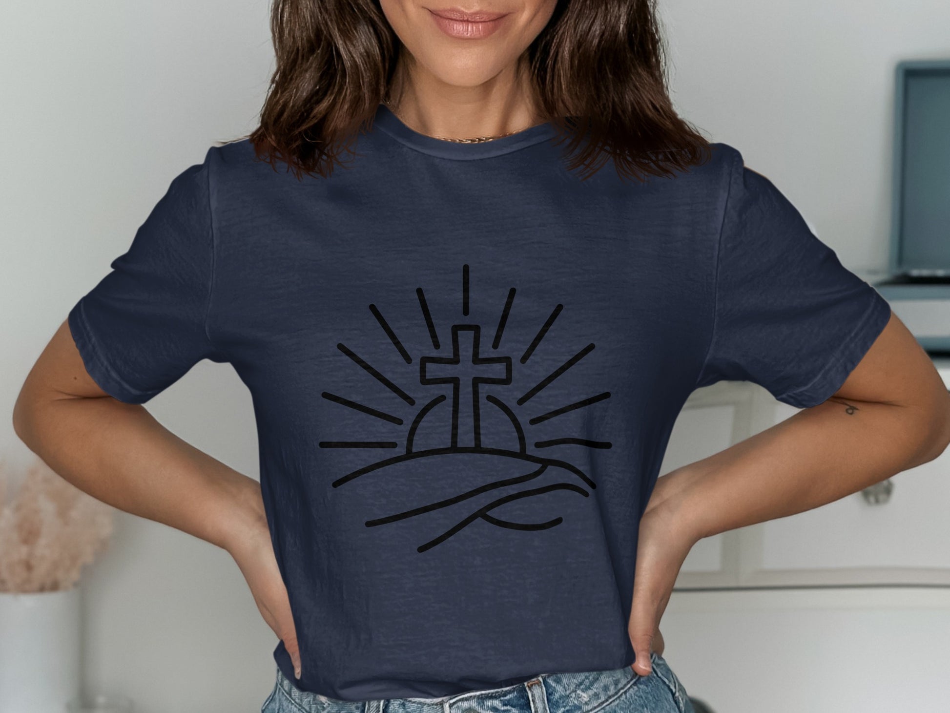 Dark navy t-shirt with a black line art graphic of a cross rising over hills.