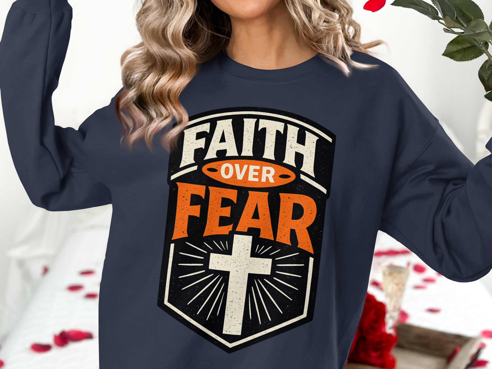 Navy sweatshirt with "FAITH OVER FEAR" and a cross graphic.