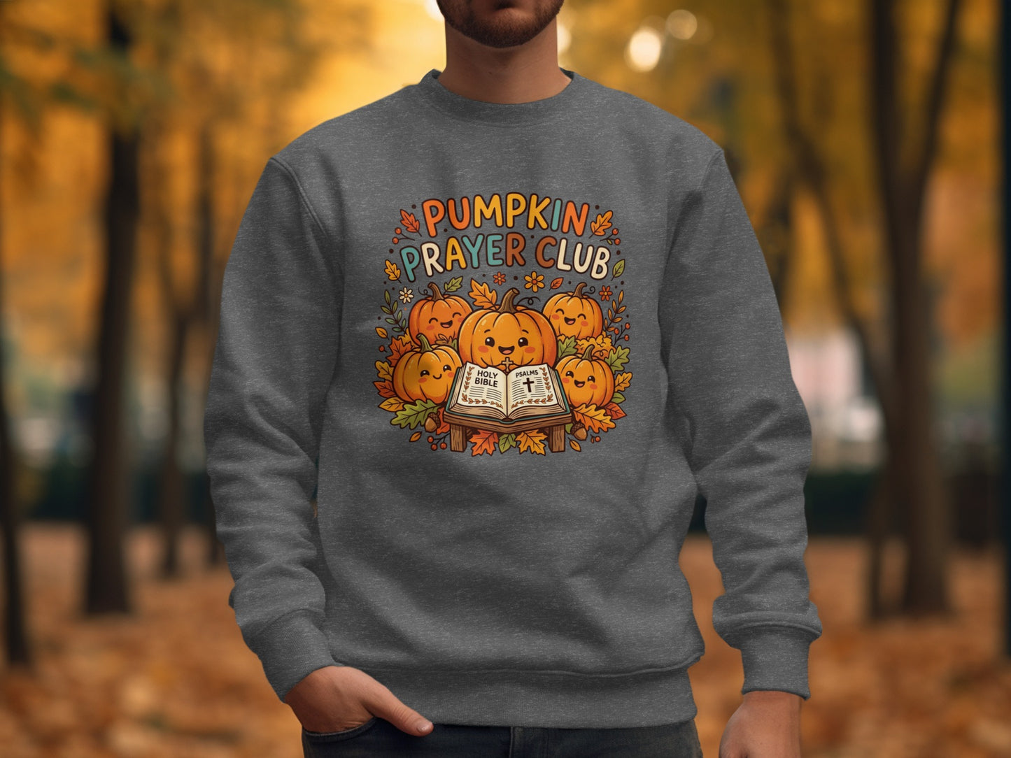 Dark gray sweatshirt with "Pumpkin Prayer Club" text and smiling pumpkins on a Bible.
