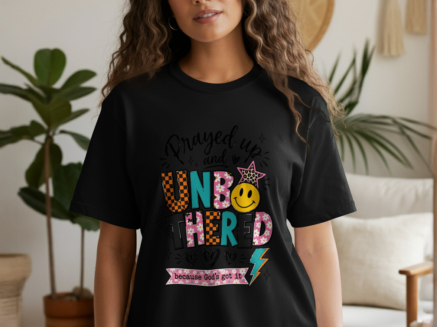 Black t-shirt with "Prayed up and UNBOTHERED because God's got it" text and graphics.