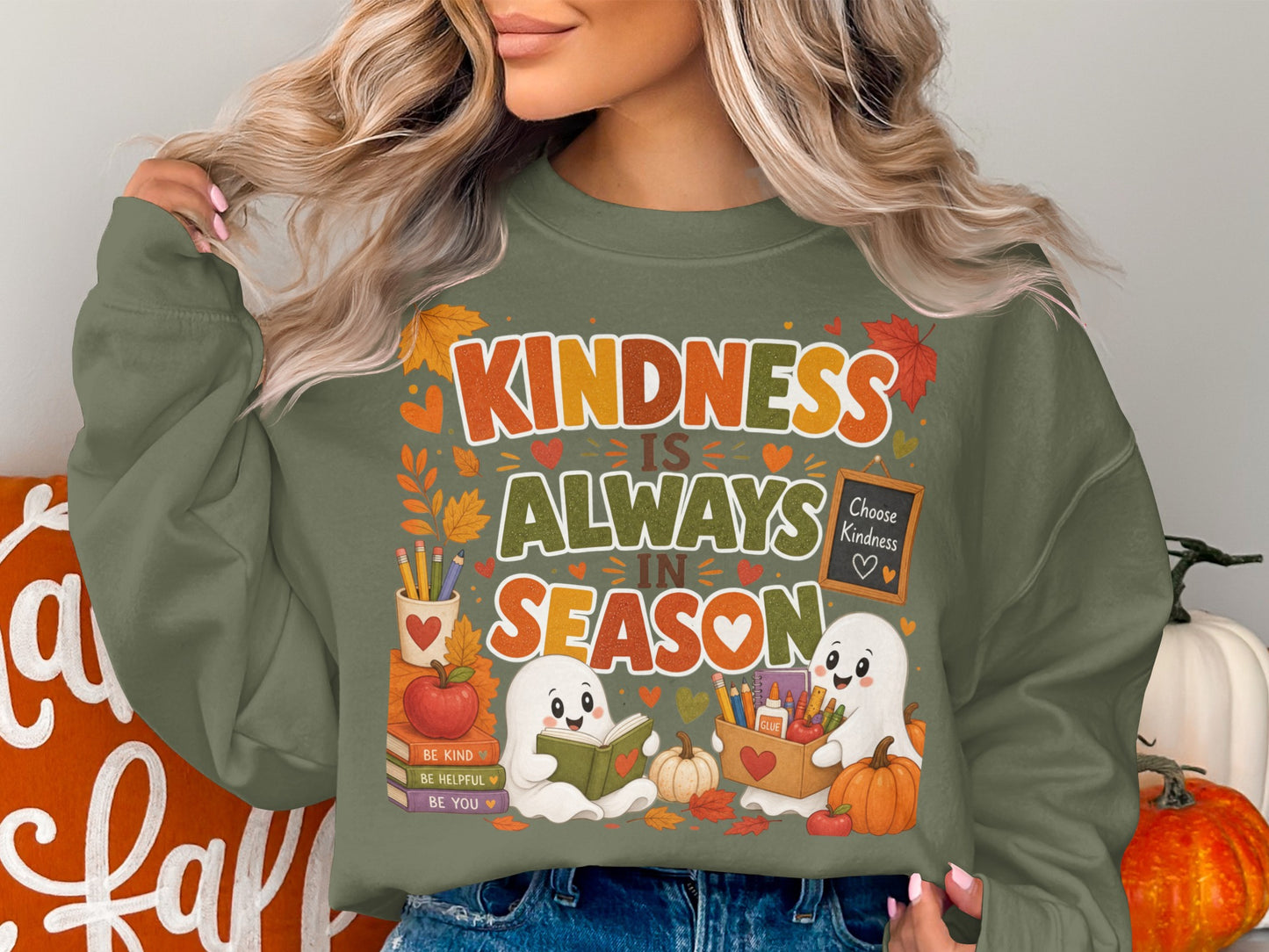 Green sweatshirt with "Kindness Is Always In Season" text and ghost graphics.