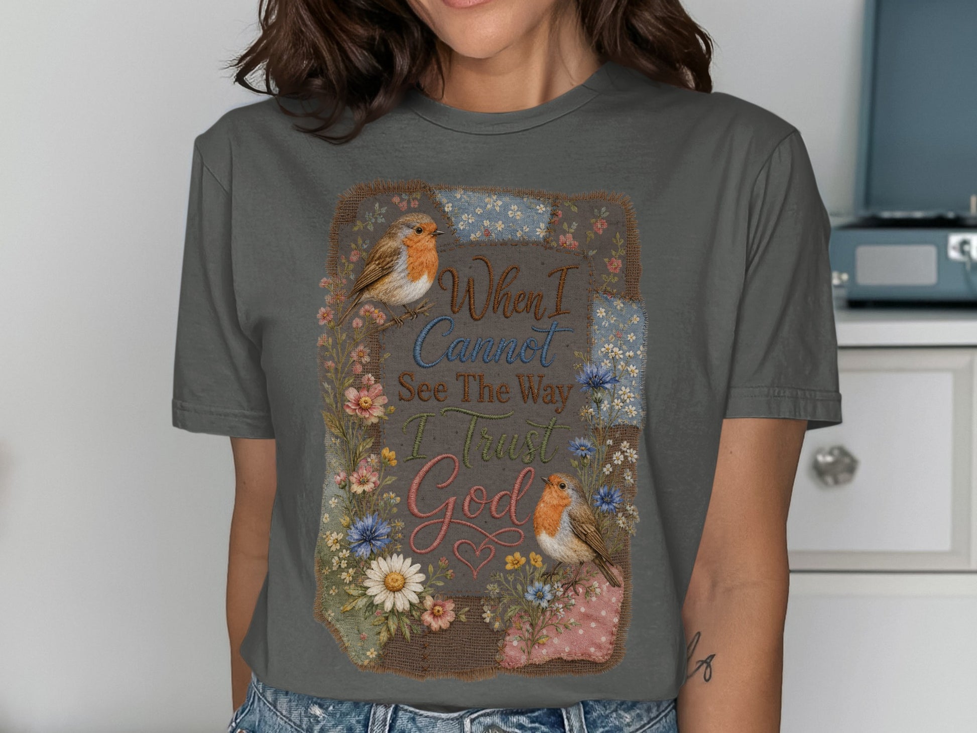 Gray t-shirt with floral border, two birds, and the text "When I Cannot See The Way I Trust God".