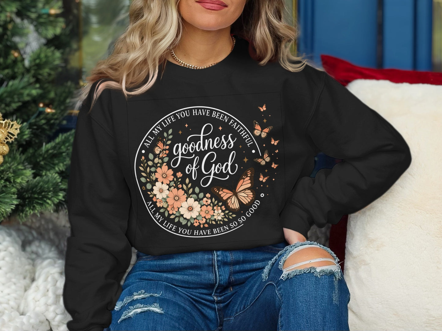 Black sweatshirt with floral circle design and "Goodness of God" text.