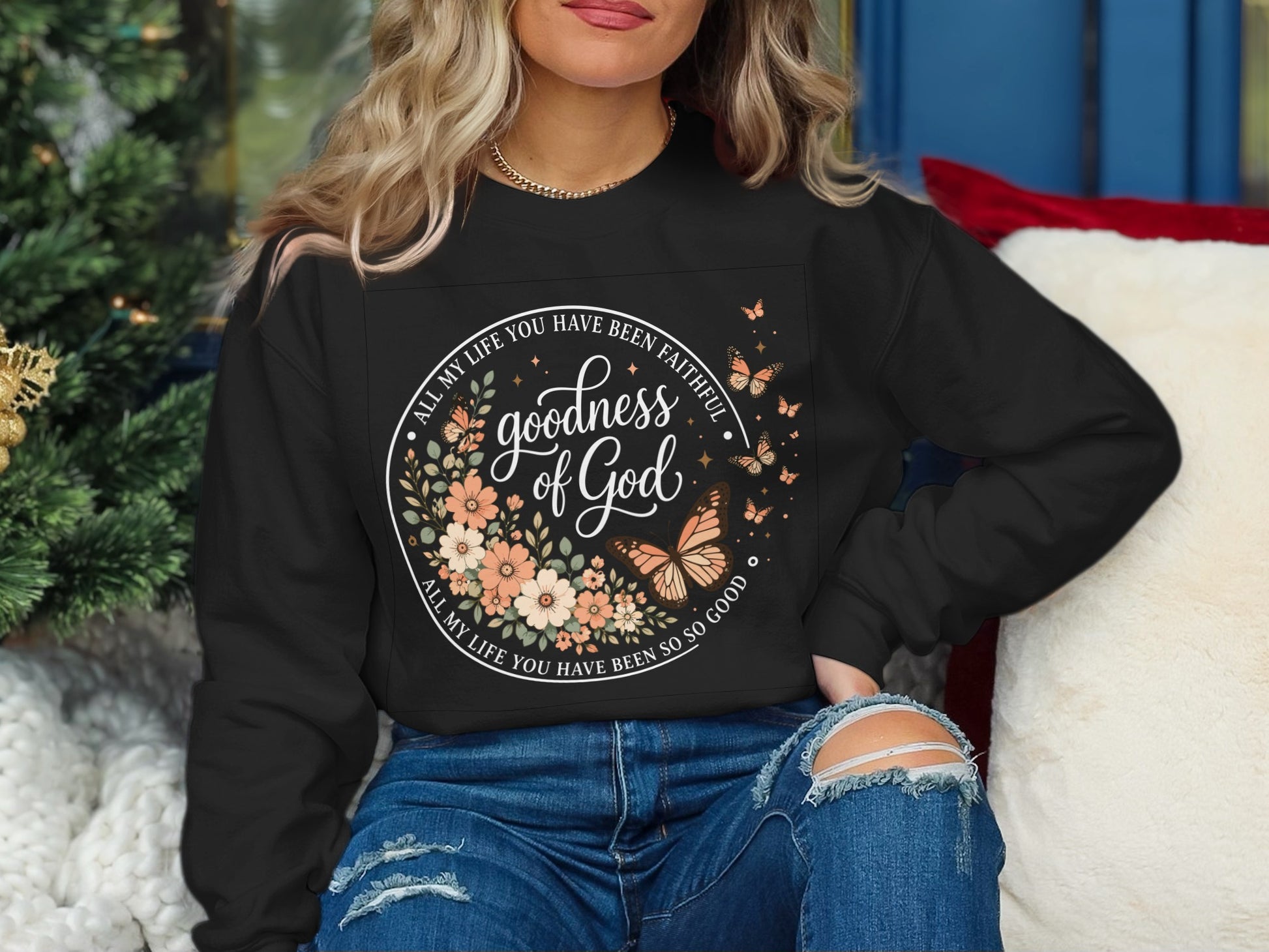Black sweatshirt with floral circle design and "Goodness of God" text.