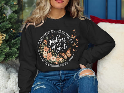 Black sweatshirt with floral circle design and "Goodness of God" text.
