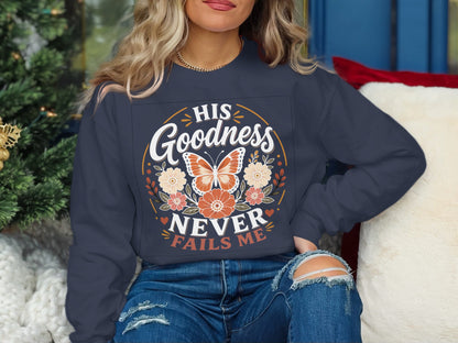 Dark navy sweatshirt with "His Goodness Never Fails Me" and a butterfly.
