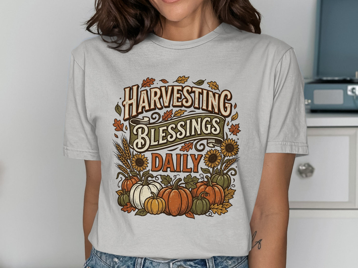 T-shirt with "Harvesting Blessings Daily" text, pumpkins, and sunflowers.