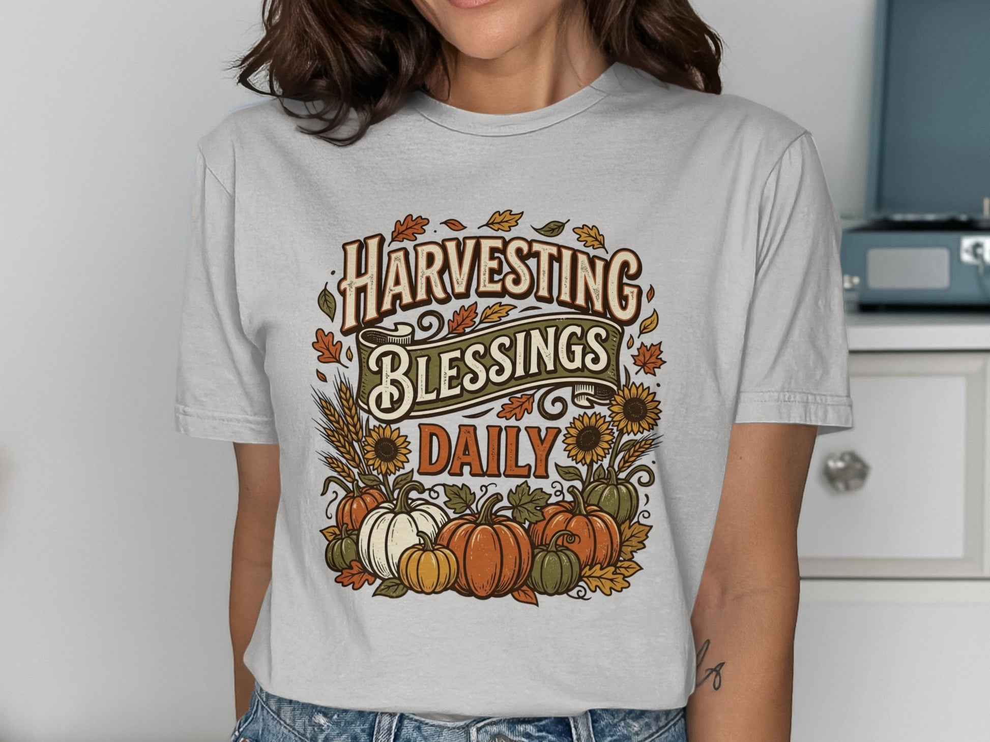 T-shirt with "Harvesting Blessings Daily" text, pumpkins, and sunflowers.