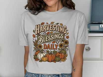 T-shirt with "Harvesting Blessings Daily" text, pumpkins, and sunflowers.