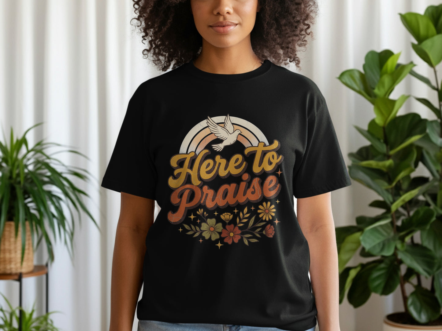 Black t-shirt with "Here To Praise" text, dove, and floral design.